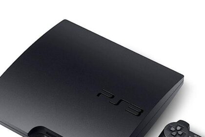 PlayStation 3 console beside a PC displaying the RPCS3 emulator interface.